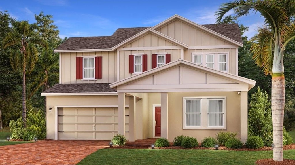 698 Peroni Ave, Debary, FL 32713 - view of front of house featuring a front lawn, decorative driveway, roof with shingles, board and batten siding, and an attached garage