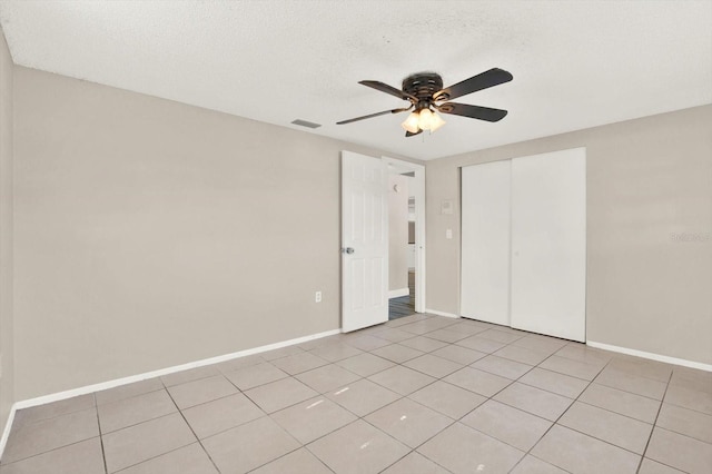 unfurnished bedroom with visible vents, a ceiling fan, baseboards, and a closet
