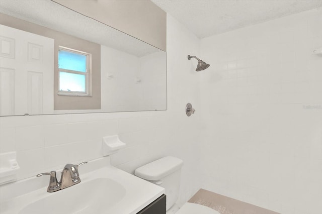 full bath featuring backsplash, tile walls, vanity, toilet, and tiled shower