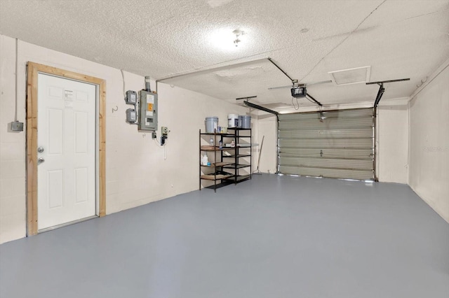 garage with a garage door opener and electric panel