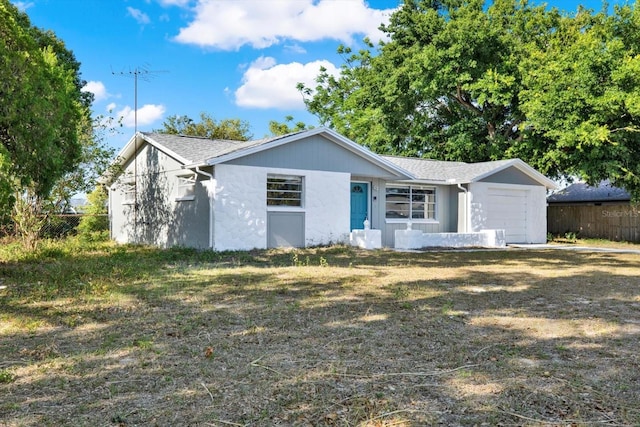 ranch-style home with fence and a garage