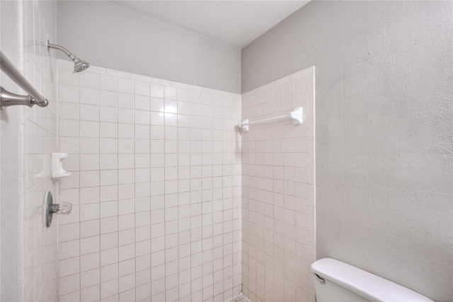 full bathroom with toilet and tiled shower