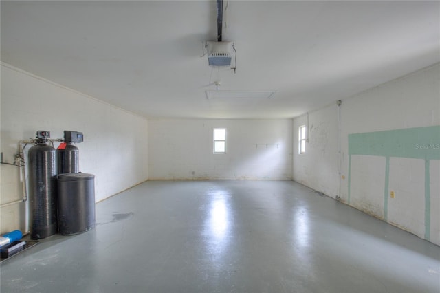 garage with concrete block wall and a garage door opener