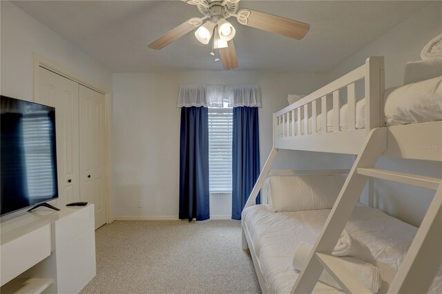 bedroom featuring baseboards, ceiling fan, and carpet flooring
