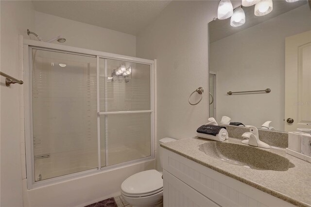 full bathroom featuring vanity, bath / shower combo with glass door, and toilet