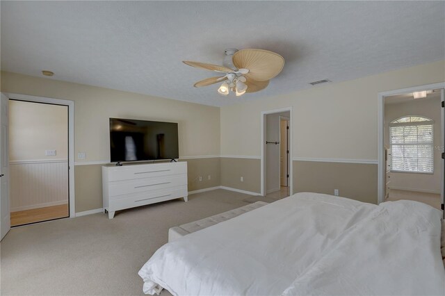bedroom featuring carpet floors, a ceiling fan, and visible vents