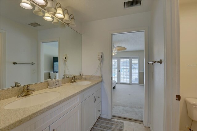 bathroom with a sink, tile patterned floors, and visible vents