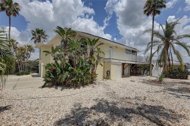 exterior space with gravel driveway and stairway