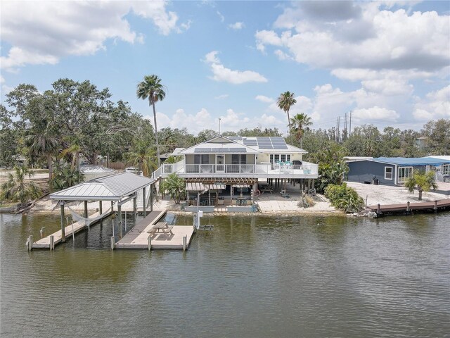 dock area featuring boat lift and a water view