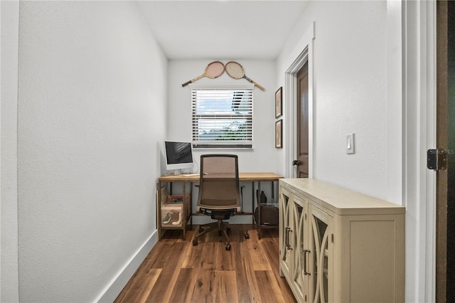office space with dark wood-style flooring and baseboards