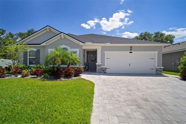 view of front of property with an attached garage, decorative driveway, stucco siding, and a front lawn