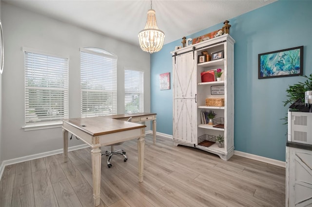 home office featuring a chandelier, light wood-style flooring, and baseboards