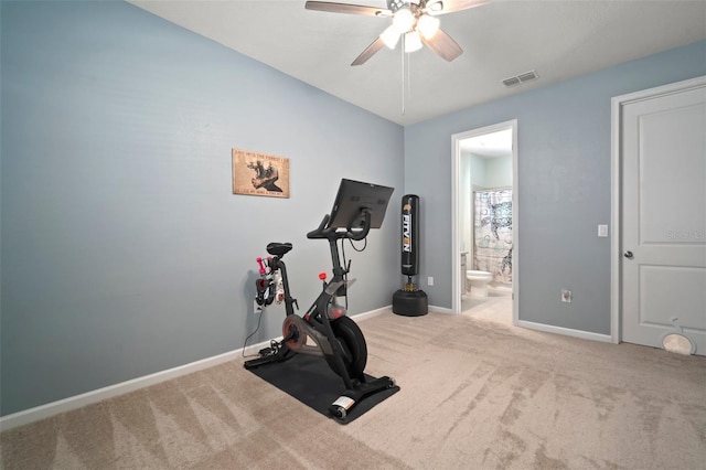 exercise area featuring baseboards, visible vents, ceiling fan, and carpet