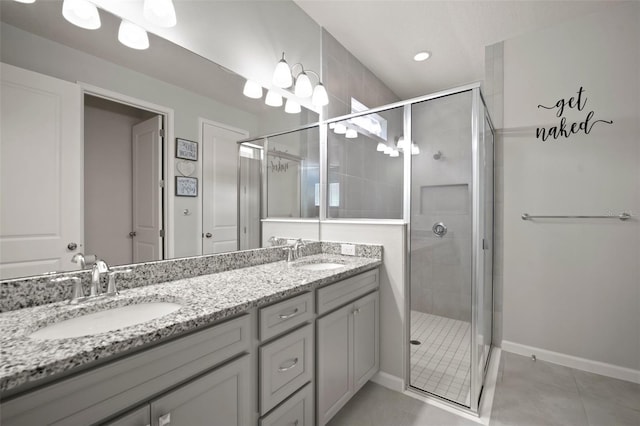 bathroom with tile patterned flooring, a stall shower, and a sink