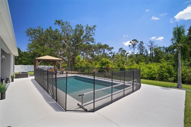 view of swimming pool featuring a gazebo, a patio area, a fenced in pool, and fence