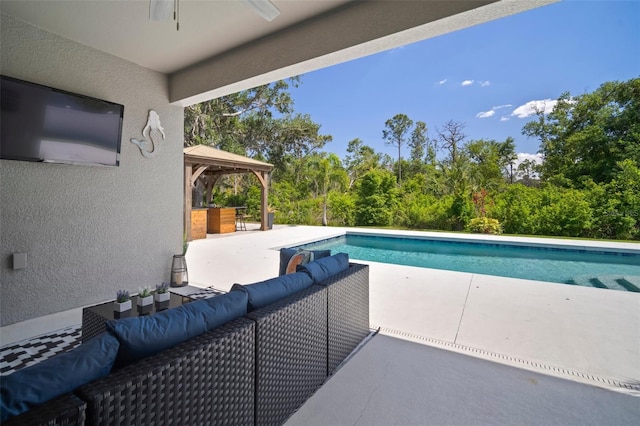 outdoor pool featuring outdoor lounge area, a patio area, a gazebo, and ceiling fan
