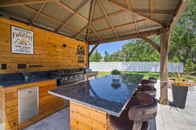 view of patio with a gazebo, fence, area for grilling, and a grill