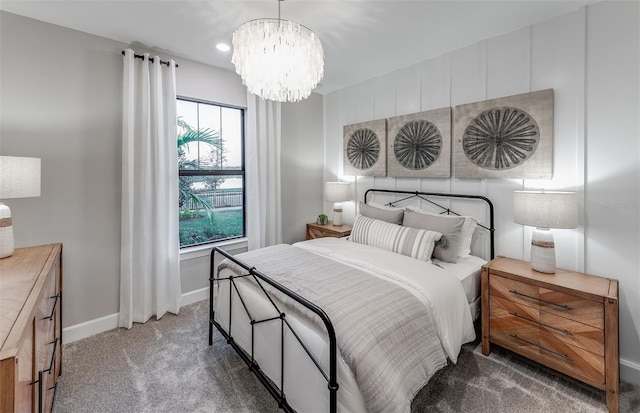 carpeted bedroom featuring baseboards, recessed lighting, and a chandelier