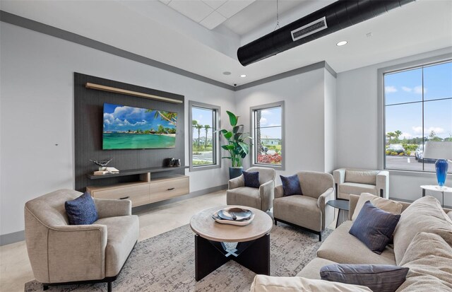 living room featuring recessed lighting, baseboards, visible vents, and plenty of natural light