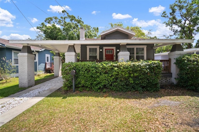 bungalow with a chimney and a front yard