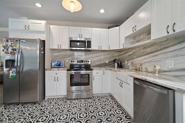 kitchen featuring a sink, white cabinets, and stainless steel appliances