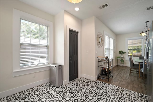 entryway featuring recessed lighting, baseboards, visible vents, and wood finished floors