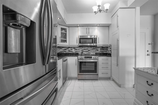 30 Turner St Unit 202, Clearwater, FL 33756 - kitchen featuring stainless steel appliances, light marble finish floors, a chandelier, and white cabinets
