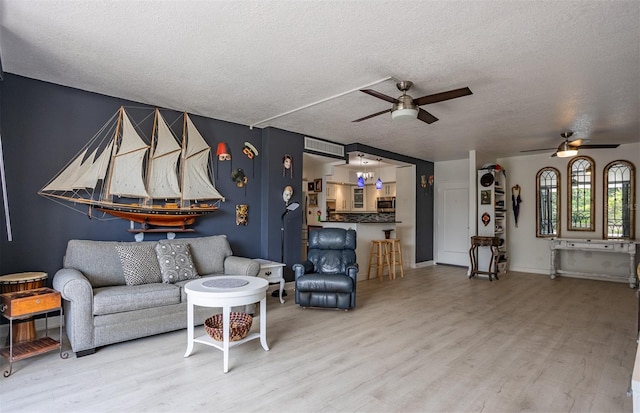 30 Turner St Unit 202, Clearwater, FL 33756 - living room with ceiling fan, wood finished floors, and a textured ceiling