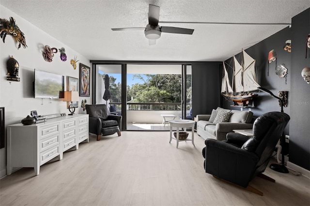 30 Turner St Unit 202, Clearwater, FL 33756 - living room with floor to ceiling windows, a textured ceiling, light wood-style floors, and ceiling fan