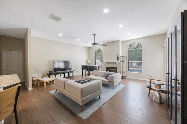 18520 Ambly Ln, Tampa, FL 33647 - living area featuring recessed lighting, wood finished floors, baseboards, ceiling fan, and a glass covered fireplace