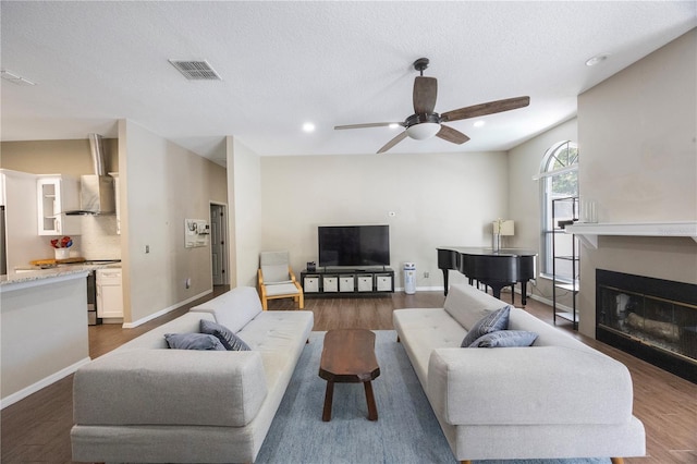 18520 Ambly Ln, Tampa, FL 33647 - living room with dark wood-style floors, a ceiling fan, a glass covered fireplace, baseboards, and recessed lighting