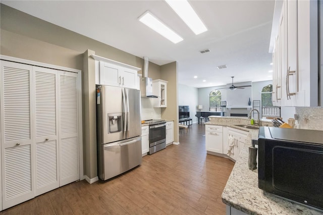 18520 Ambly Ln, Tampa, FL 33647 - kitchen featuring stainless steel appliances, a sink, white cabinets, a ceiling fan, and light wood-style floors