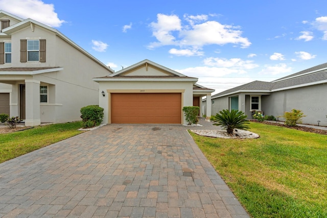 11819 Brighton Knoll Loop, Riverview, FL 33579 - view of front of property featuring stucco siding, a front lawn, decorative driveway, and an attached garage
