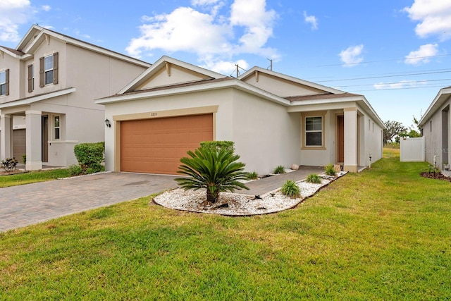 11819 Brighton Knoll Loop, Riverview, FL 33579 - view of front facade with stucco siding, driveway, an attached garage, and a front lawn