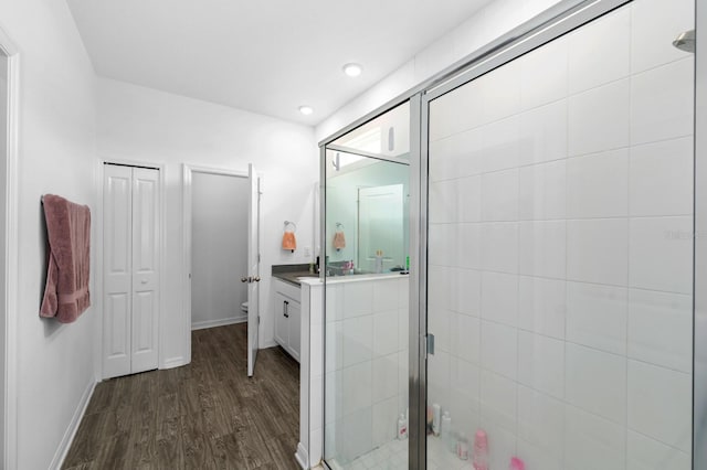 11819 Brighton Knoll Loop, Riverview, FL 33579 - full bath featuring wood finished floors, toilet, vanity, a stall shower, and baseboards