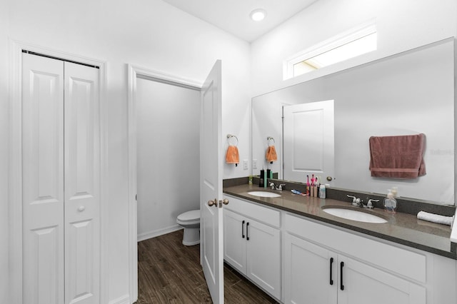 11819 Brighton Knoll Loop, Riverview, FL 33579 - full bathroom with toilet, double vanity, wood finished floors, a closet, and baseboards
