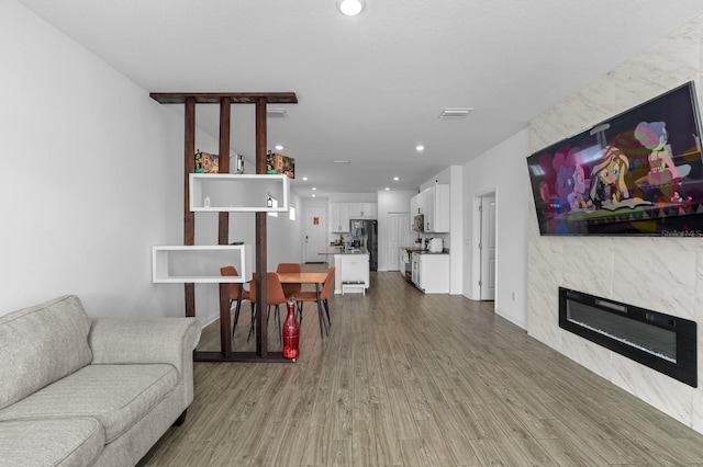 11819 Brighton Knoll Loop, Riverview, FL 33579 - living room featuring wood finished floors, a high end fireplace, and recessed lighting