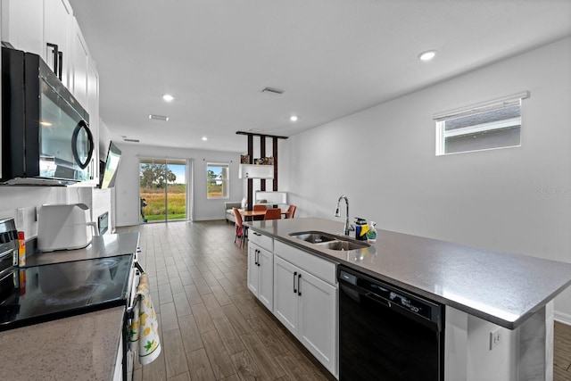 11819 Brighton Knoll Loop, Riverview, FL 33579 - kitchen with black appliances, a sink, open floor plan, white cabinetry, and dark wood-style flooring