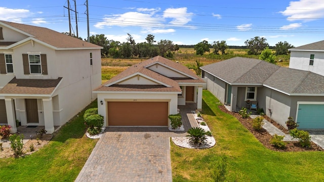 11819 Brighton Knoll Loop, Riverview, FL 33579 - view of front of property featuring a garage, decorative driveway, a front lawn, and stucco siding