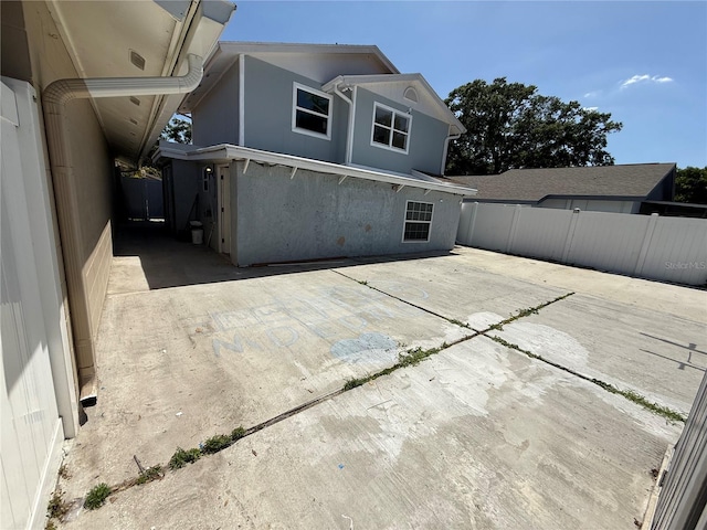 back of property featuring a patio area, stucco siding, and fence