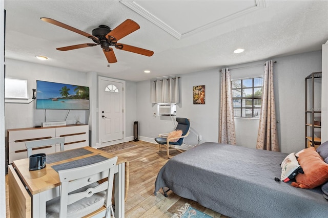 bedroom with recessed lighting, a textured ceiling, wood finished floors, and cooling unit