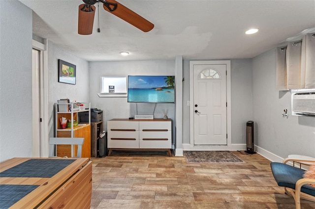 interior space featuring a ceiling fan, baseboards, recessed lighting, and light wood-style floors