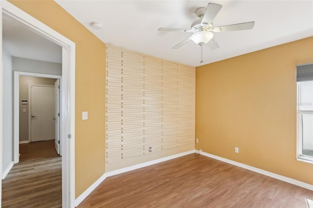 unfurnished bedroom featuring baseboards, ceiling fan, and wood finished floors