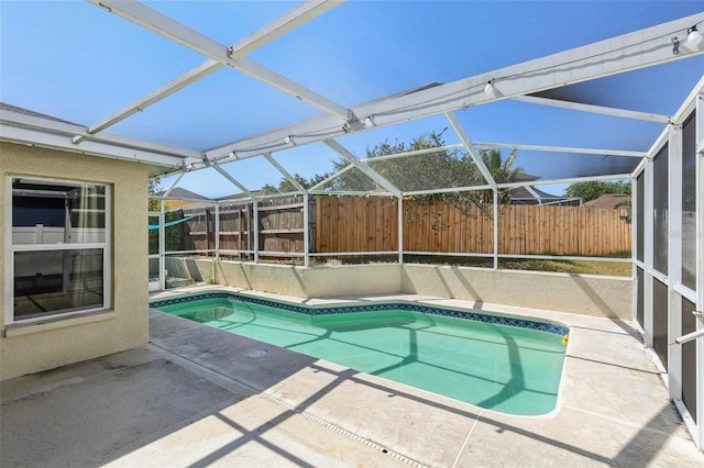 view of swimming pool featuring a fenced in pool, glass enclosure, a patio area, and fence