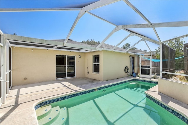 pool with a lanai and a patio area