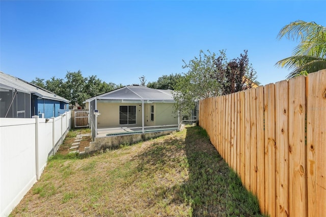 back of house with a lawn, a fenced backyard, and a patio area