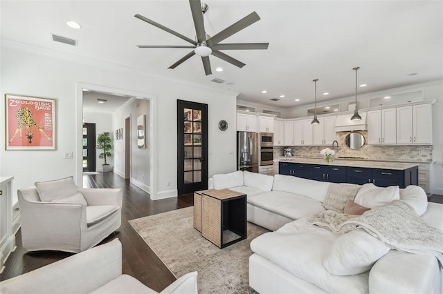 living area featuring ceiling fan, visible vents, ornamental molding, recessed lighting, and dark wood-type flooring