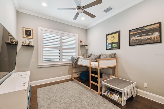 bedroom with visible vents, ornamental molding, and wood finished floors