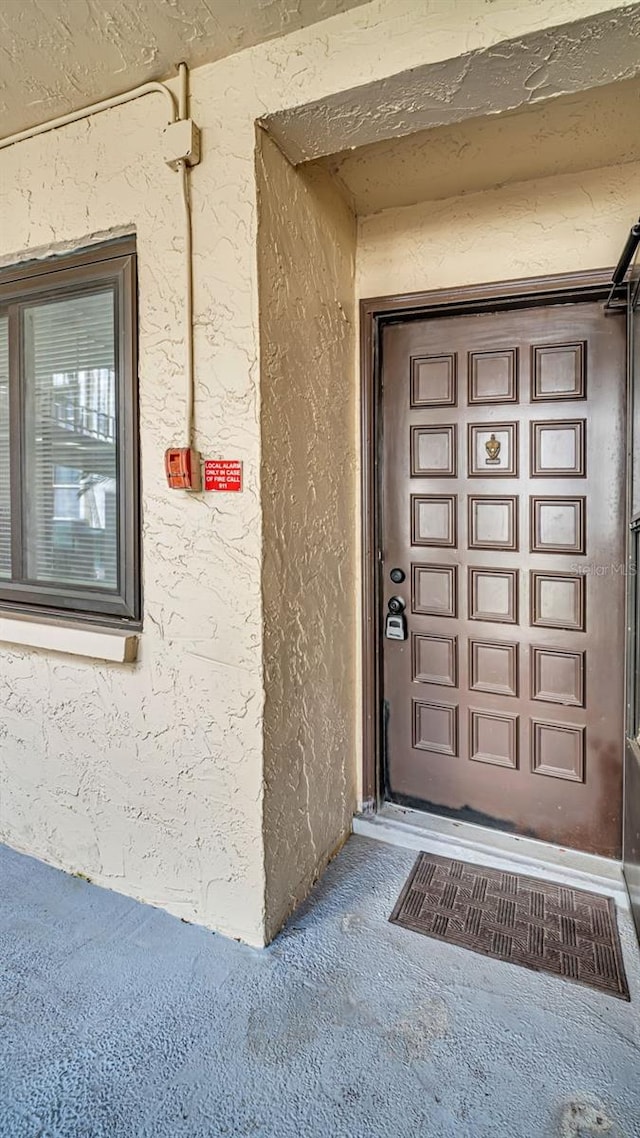 entrance to property with stucco siding