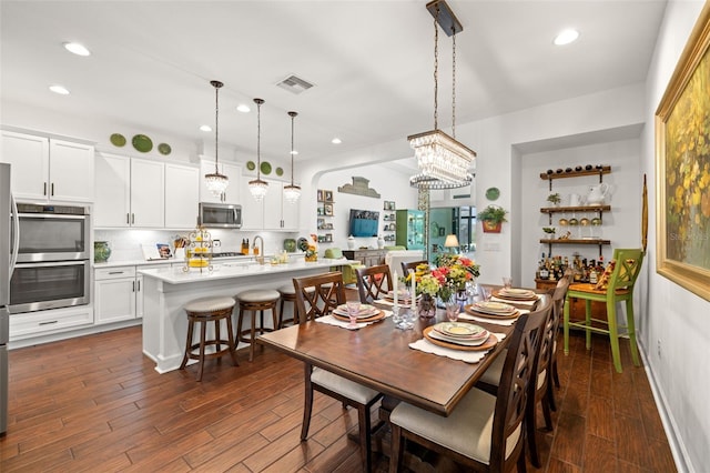 dining area featuring visible vents, recessed lighting, dark wood-style flooring, and a chandelier